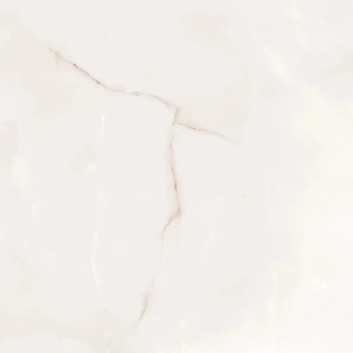 A close-up of a light warm off-white or cream surface with soft beige marbling and faint natural-looking veining.