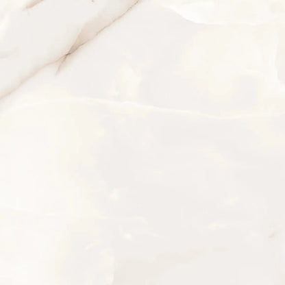 A close-up of a glossy white marble surface with soft cream veining and subtle tonal variation.